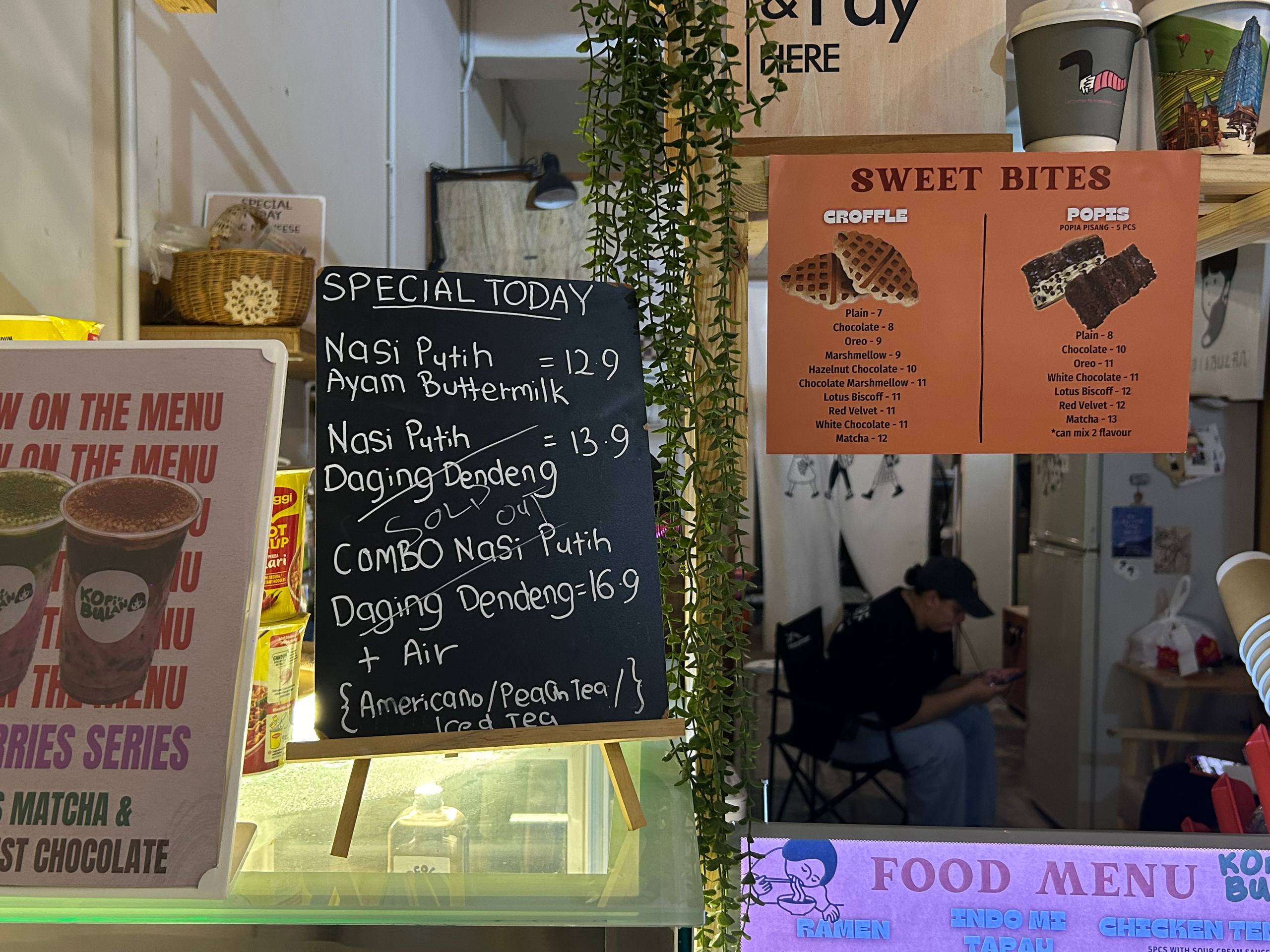 Handwritten specials and sweet bites menus at the café counter