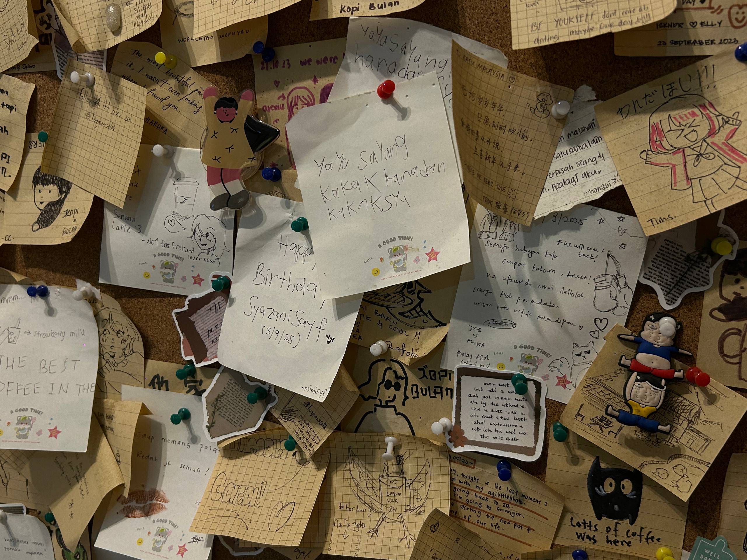 Handwritten messages, drawings and memories pinned by customers to the community board.